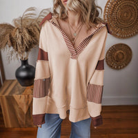 Front view of the oversized v-neck striped sweatshirt