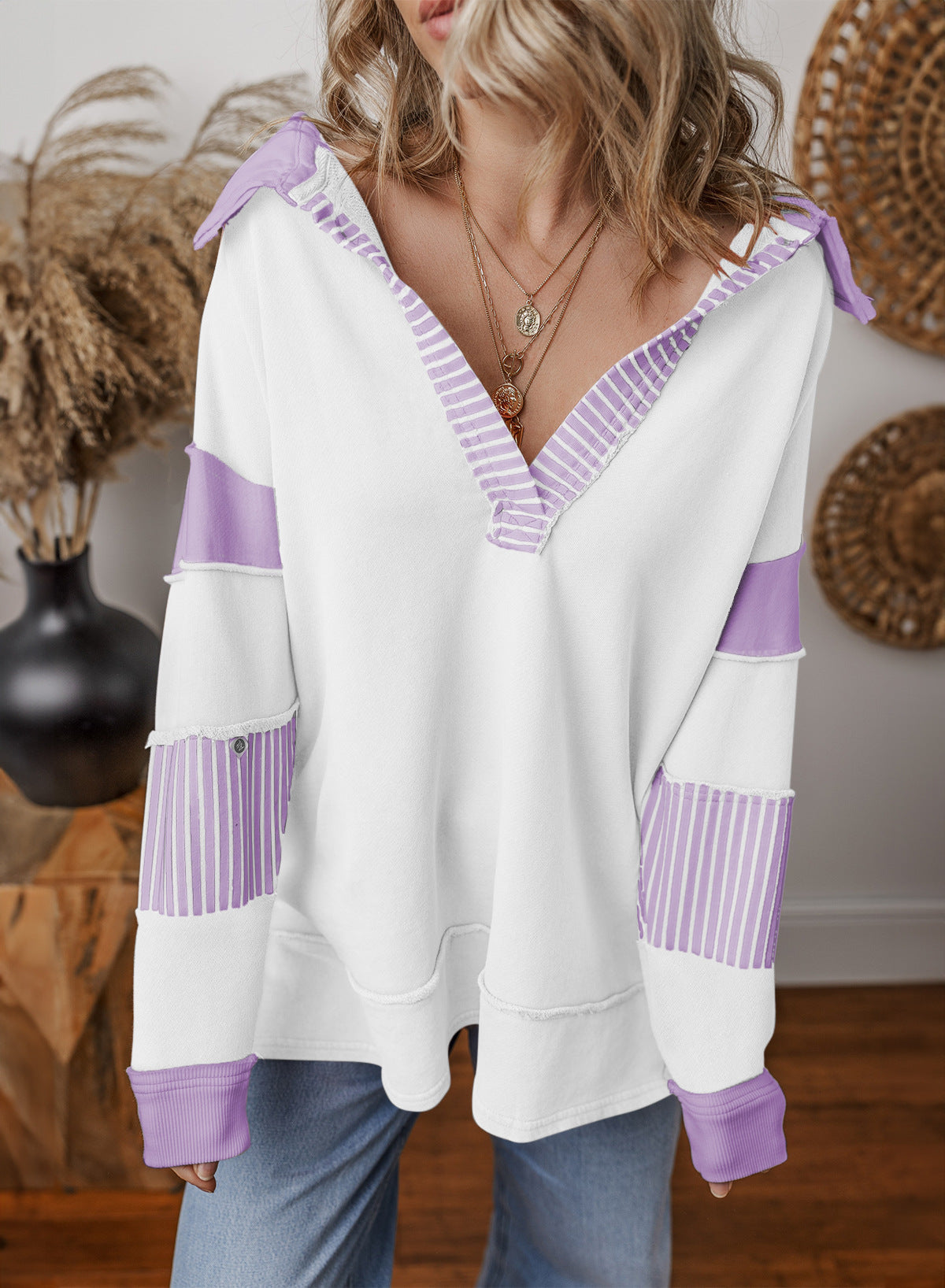 Woman wearing the oversized v-neck striped sweatshirt