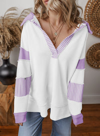 Woman wearing the oversized v-neck striped sweatshirt