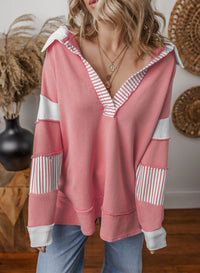 Detail of the oversized v-neck striped sweatshirt