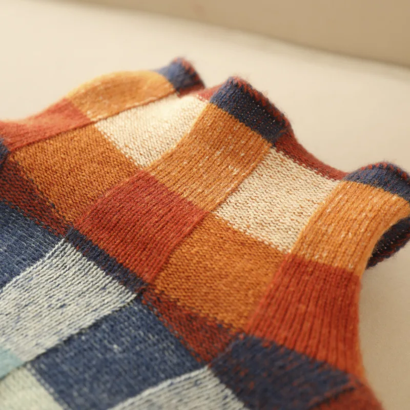 Turtleneck detail in rust, teal and navy check knit