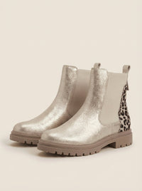 Back view of the brynn | gold chelsea boots with leopard heel