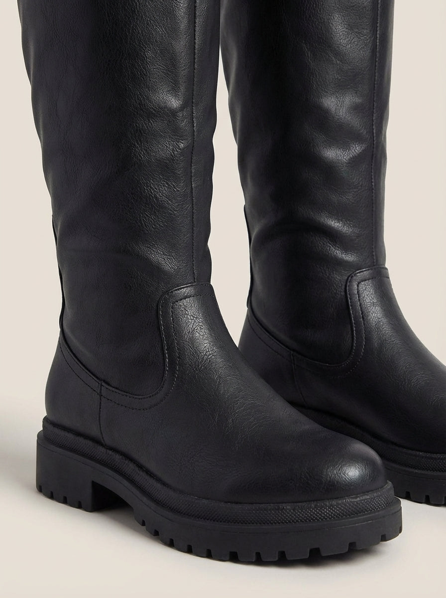 Front view of the anetta | black knee-high lug-sole boots