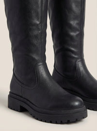 Front view of the anetta | black knee-high lug-sole boots