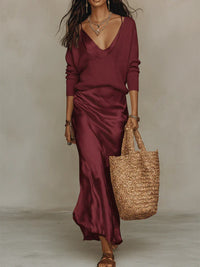 Woman wearing the elena satin midi dress with matching sweater