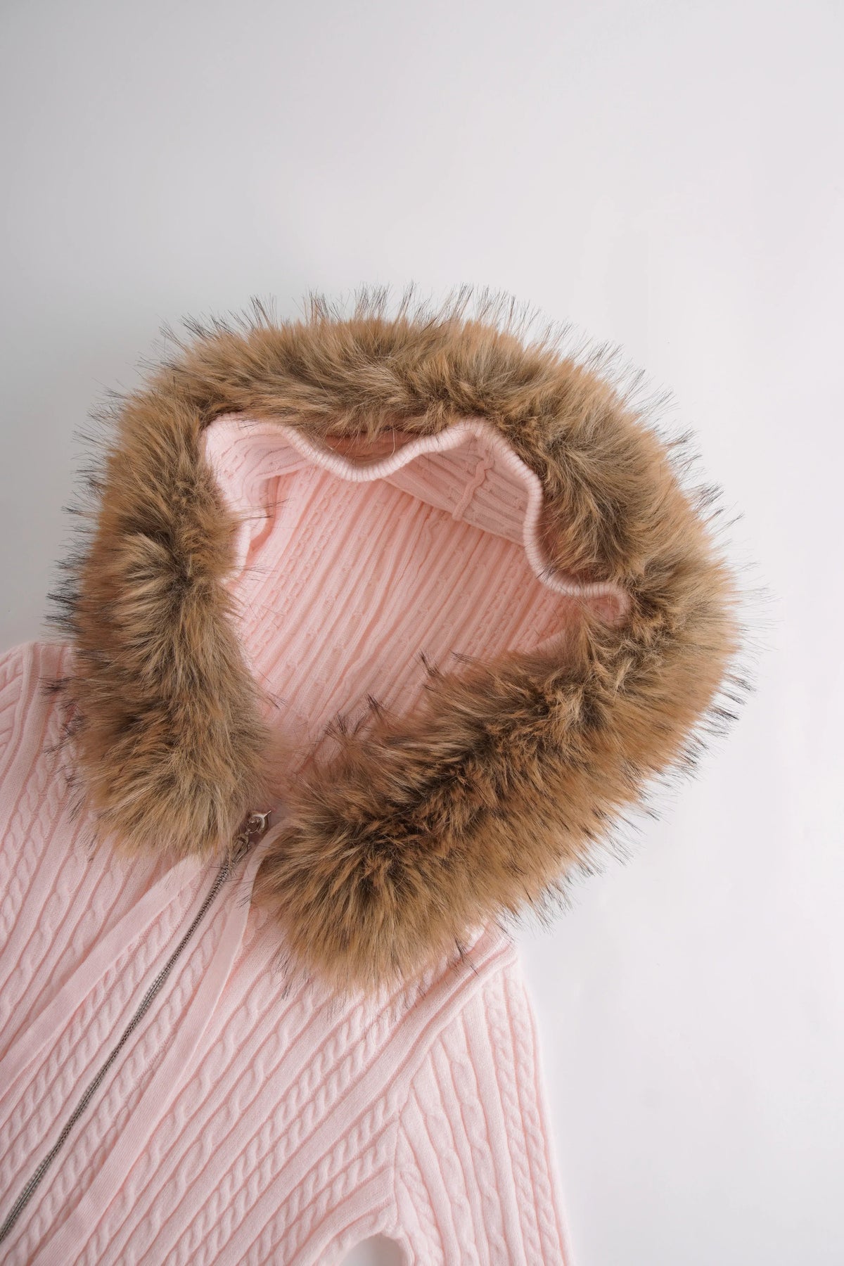 Side profile of the fur trim strawberry milk cable knit cardigan (pink)