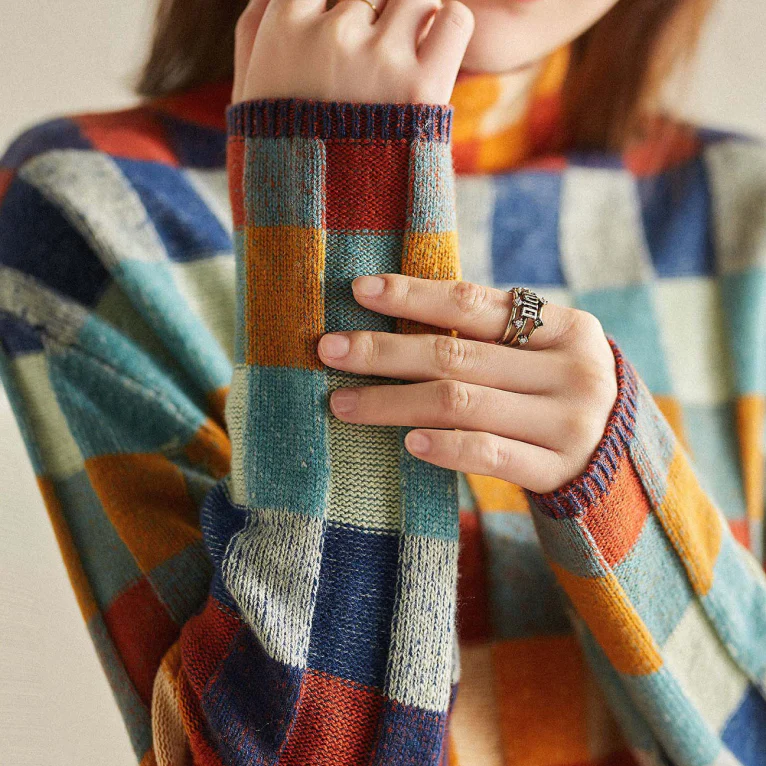 Sleeve detail of the patchwork check turtleneck sweater