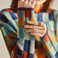 Sleeve detail of the patchwork check turtleneck sweater