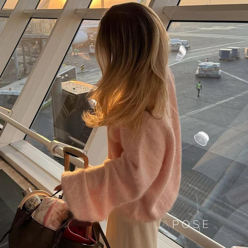 Woman wearing the selene off-shoulder knit sweater