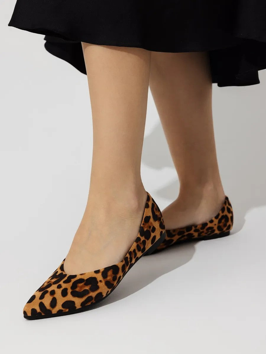 Woman wearing the leopard pointed-toe ballet flats in leopard