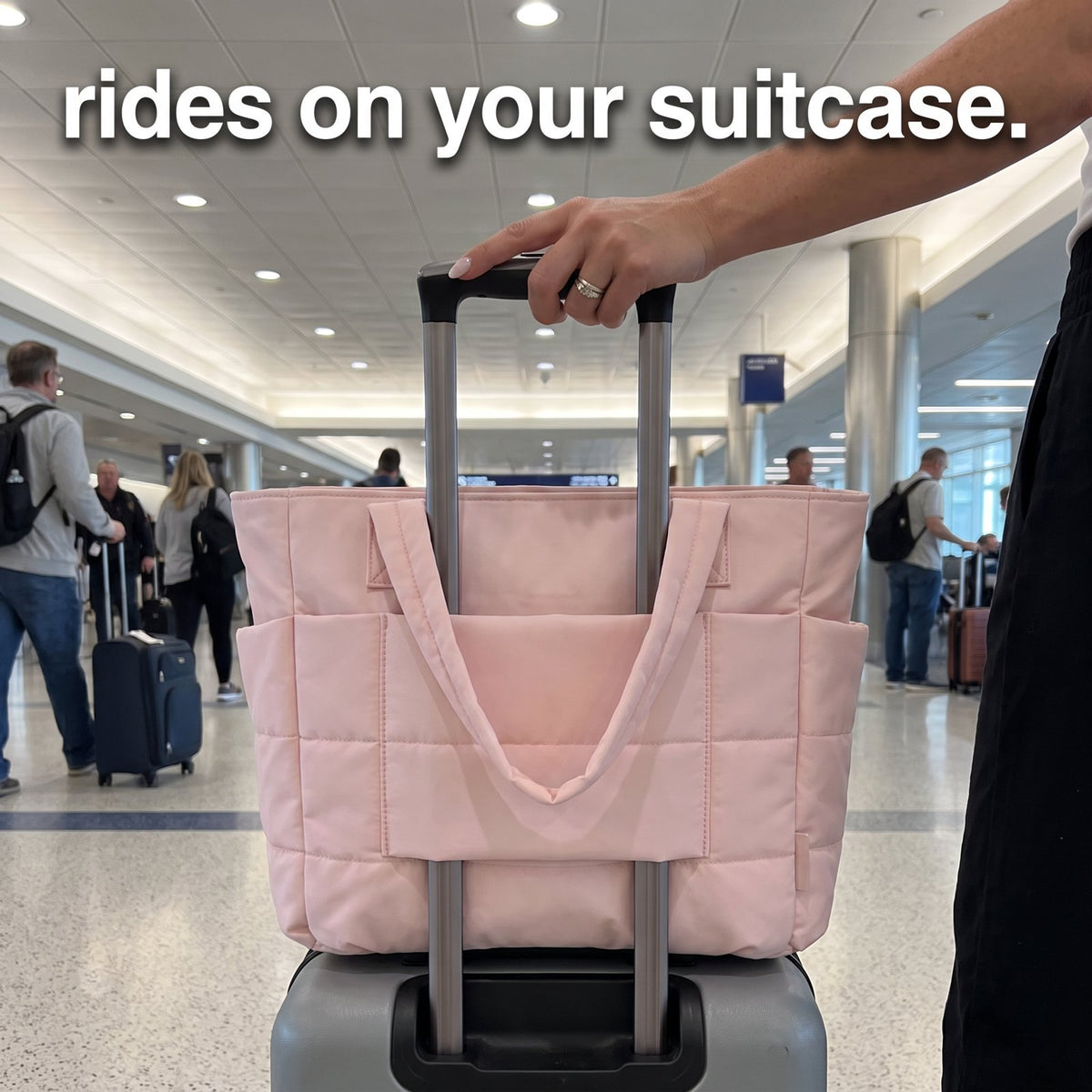 The Pillow Tote rides on a carry-on suitcase