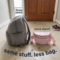 The Freehand crossbody bag next to a bulky diaper backpack