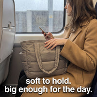 Woman on a commuter train with The Pillow Tote on her lap