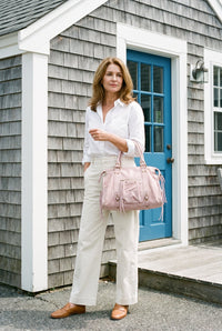 Pink suede studded shoulder bag styled on Cape Cod for women 50+ – Susan & Anne