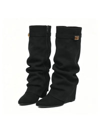Woman wearing the slouchy fold-over lock knee-high boots in black